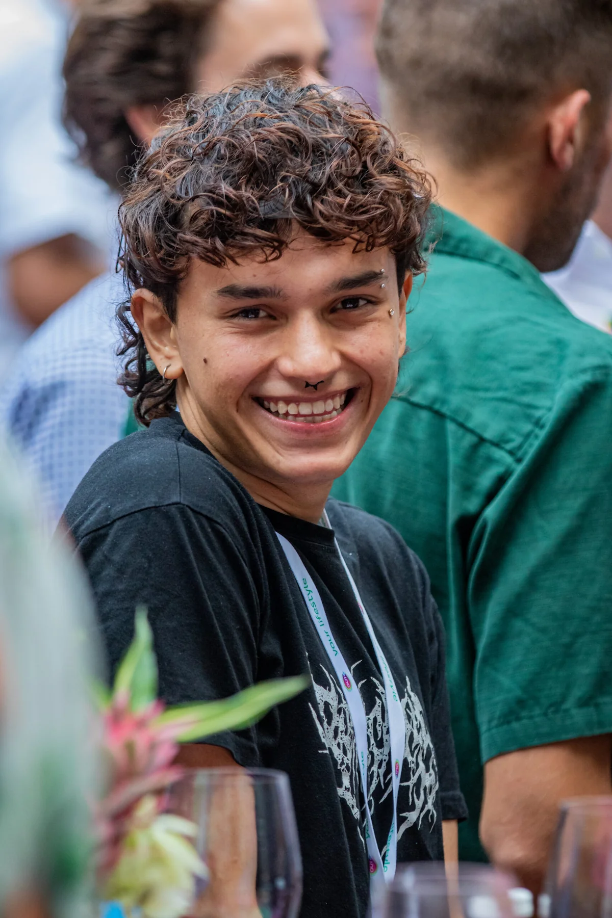 Portrait of Sebastián Ortiz Colombian model at Amsterdam Pride, smiling and radiating confidence and authenticity.