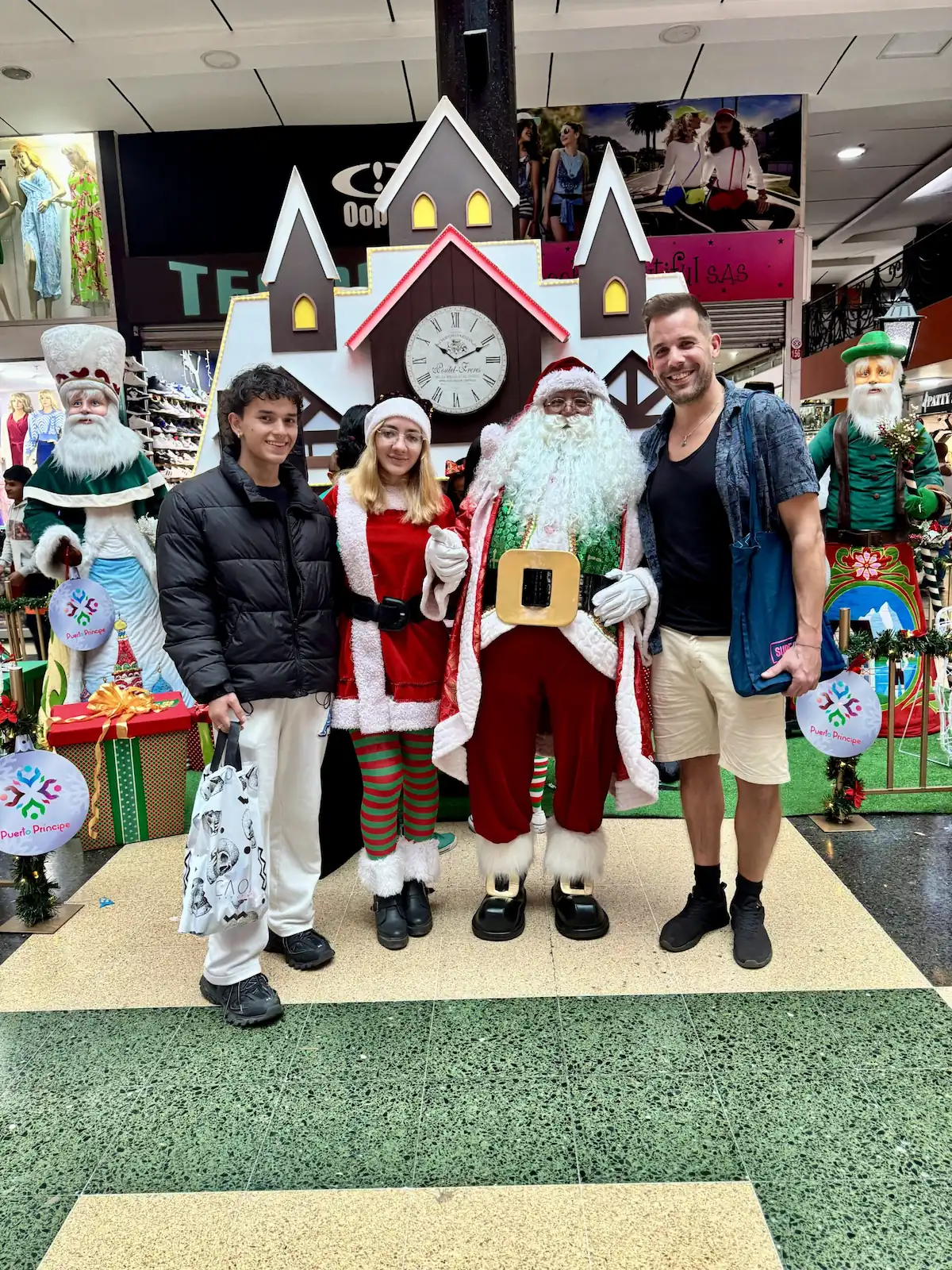 Lars and Sebas celebrating Christmas in Bogotá with Santa Claus and his helpers at a shopping mall.