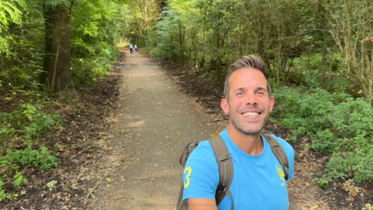 Lars Brunnhoff smiling on a forest path in Germany, reflecting on his mindset growth journey.
